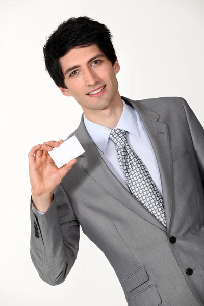 Portrait of handsome businessman holding business card — Stock Photo, Image