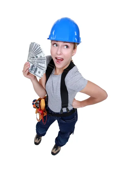 Female electrician holding bunch of dollars — Stock Photo, Image