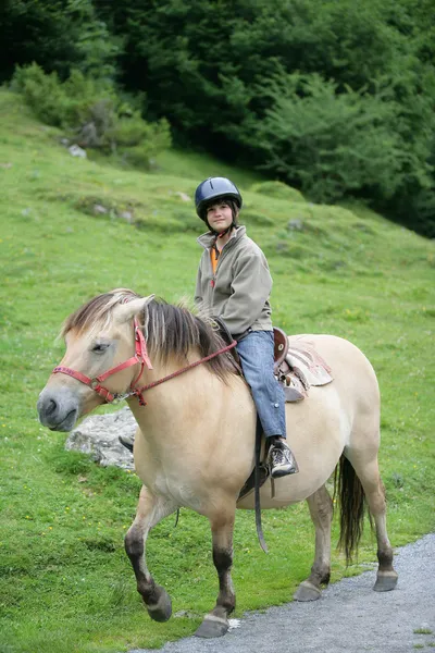 Boy riding a pony — Stock Photo, Image