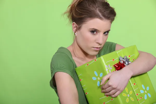 Mujer codiciosa abrazando su regalo a sí misma —  Fotos de Stock