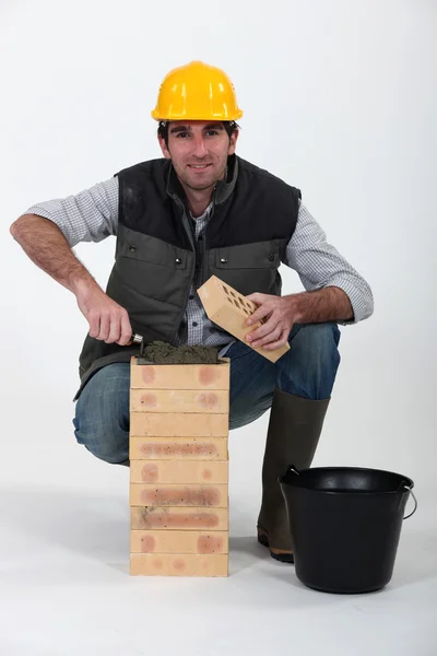 Portrait of bricklayer against studio background — Stock Photo, Image