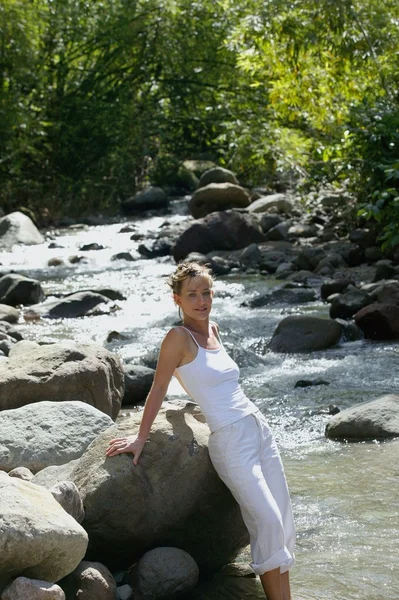Woman standing in a river — Stock Photo, Image