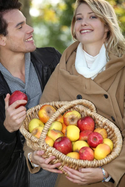 Met een mand met appelen (echt) paar — Stockfoto