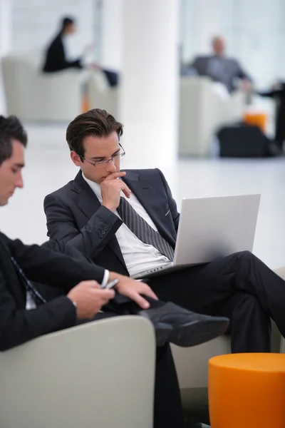 Businessmen waiting in airport lounge — Stock Photo, Image