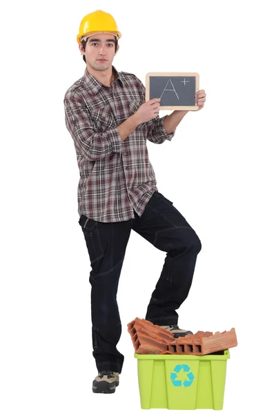 Man grading himself on his recycling efforts — Stock Photo, Image