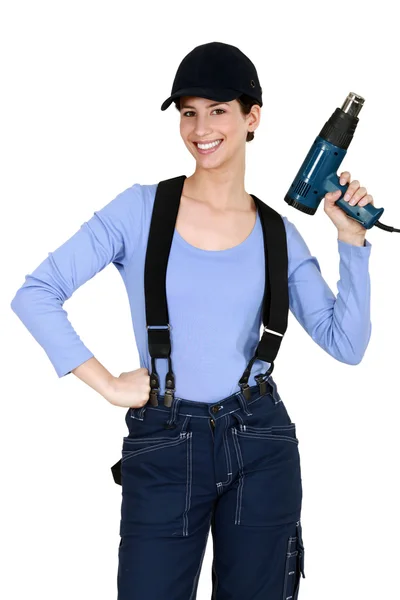 Woman holding up an electric screwdriver — Stock Photo, Image
