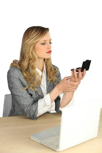 Young woman making up on her workplace — Stock Photo, Image