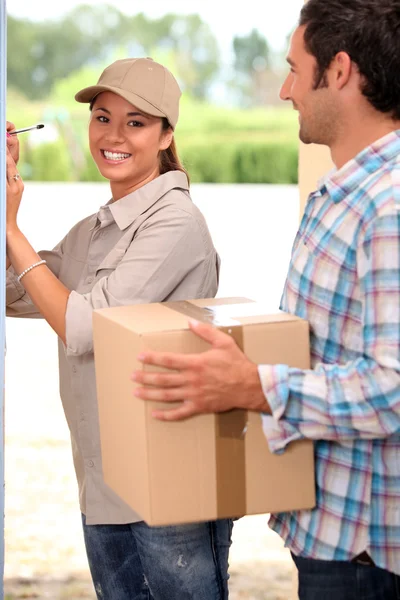 Pretty delivery girl doing her job — Stock Photo, Image
