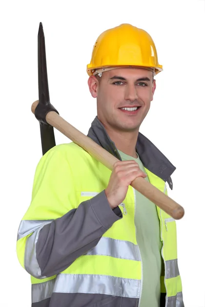 Tradesman carrying a pickaxe — Stock Photo, Image