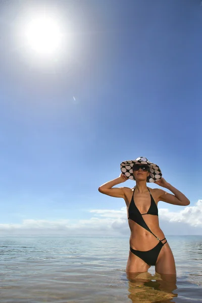 Woman in a bikini and polka dot hat — Stock Photo, Image
