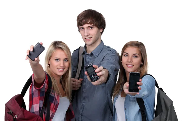 Teenagers showing mobile phones Stock Photo