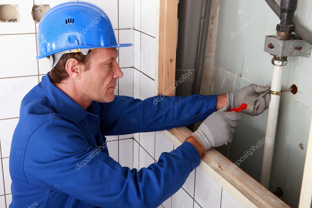 Plumber working on water pipes — Stock Photo © photography33 9211898