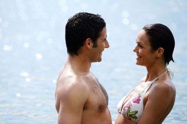 Couple in front of the beach clipart