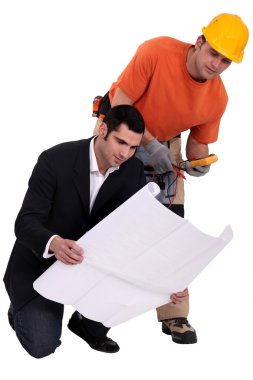 Electrician and architect looking at plans clipart