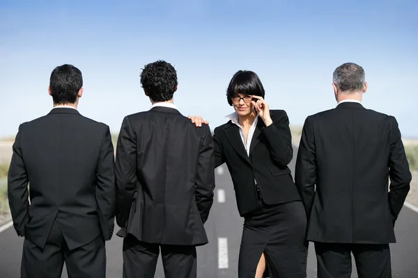 Woman in suit standing near men in suit — Stock Photo, Image