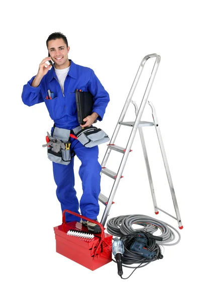 Eletricista com ferramentas e telefone — Fotografia de Stock