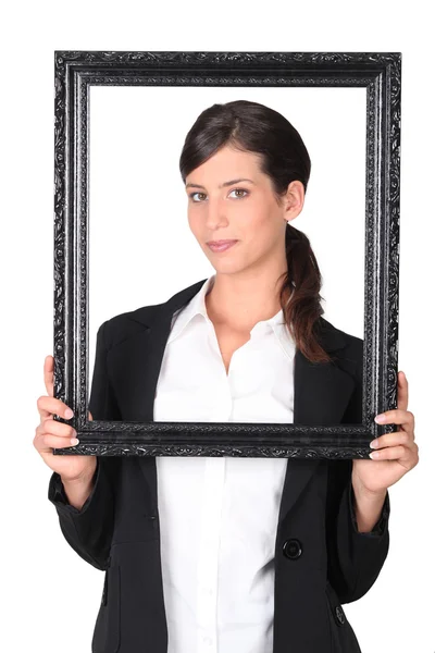 Woman holding empty picture frame — Stock Photo, Image
