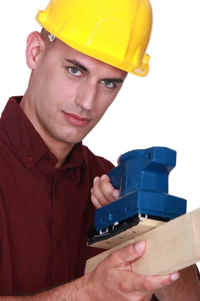 Man with an electric sander — Stock Photo, Image