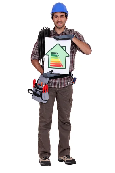 Tradesman holding an energy efficiency rating chart — Stock Photo, Image