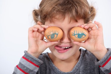 Child playing with eggs clipart