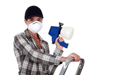 Woman holding a spray gun clipart