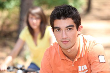 Young couple on a bike ride together clipart