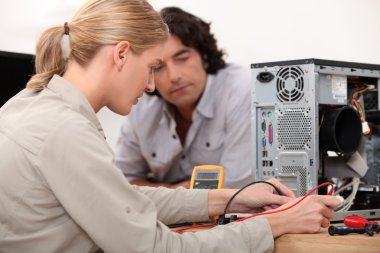 Woman fixing a hard drive clipart