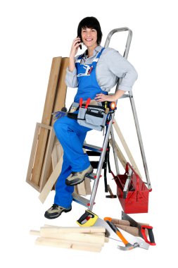 Tradeswoman talking on her mobile phone clipart