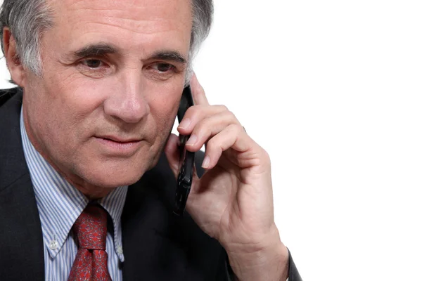 Oudere zakenman met een mobiele telefoon — Stockfoto
