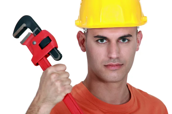 Tradesman holding a pipe wrench — Stock fotografie