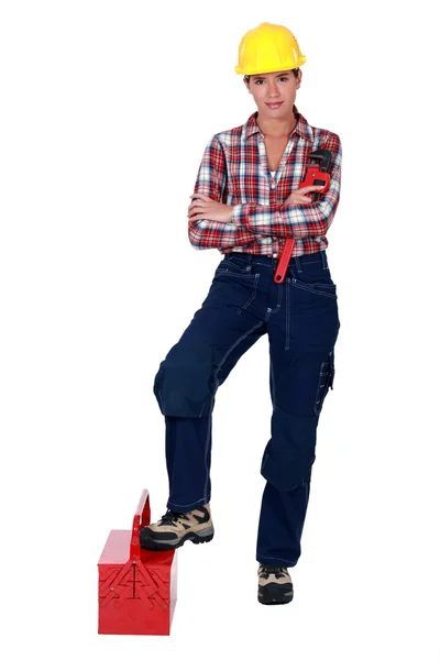 Female plumber standing on white background — Stock Photo, Image