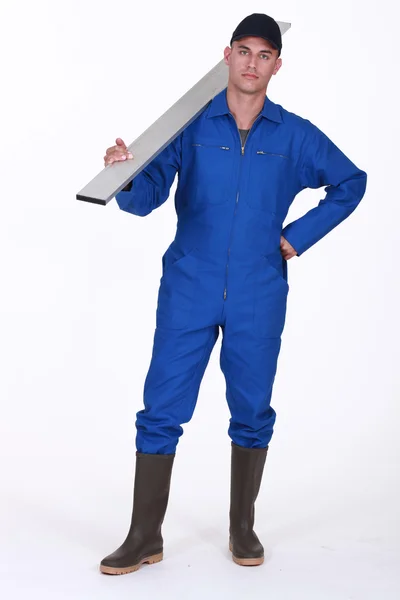 Craftsman holding a board on his shoulder — Stock Photo, Image