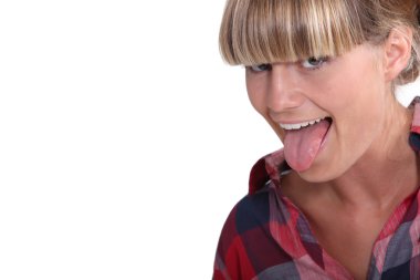 A blond teenager pulling her tongue out. clipart