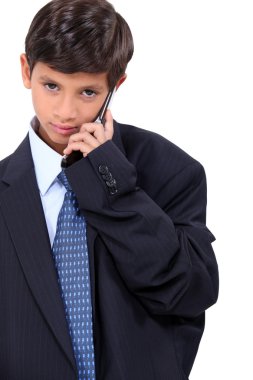 Young boy dressed in a adult's business suit clipart