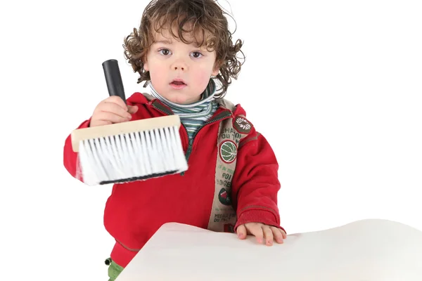Young child holding a brush — Stock Photo, Image