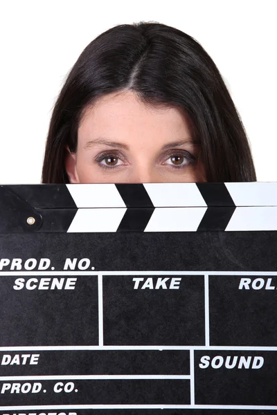Woman holding movie clapper — Stock Photo, Image
