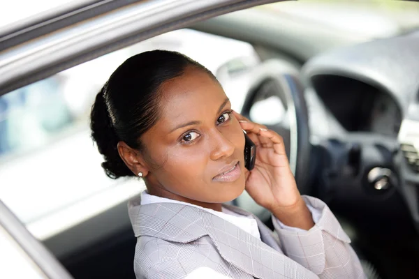 stock image Woman in a car using a cellphone