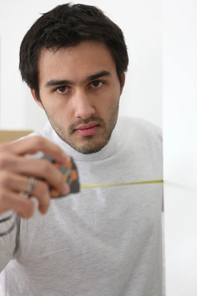 Man with a tape measure — Stock Photo, Image