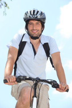 Young on bike with helmet clipart