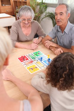 Family playing board game together clipart