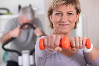 Senior couple in the gym clipart