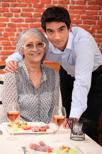 Kleinzoon en grootmoeder in restaurant — Stockfoto