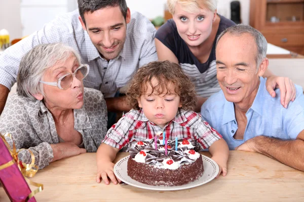 Family celebrating birthday boy — Stock Photo, Image
