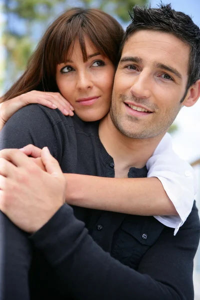 Attractive couple hugging outdoors — Stock Photo, Image