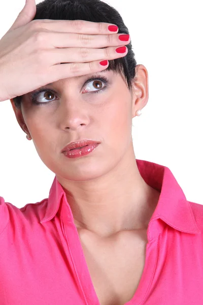 Young woman touching her forehead — Stock Photo, Image