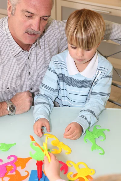 Grandfather playing with grandson — Stock Photo, Image