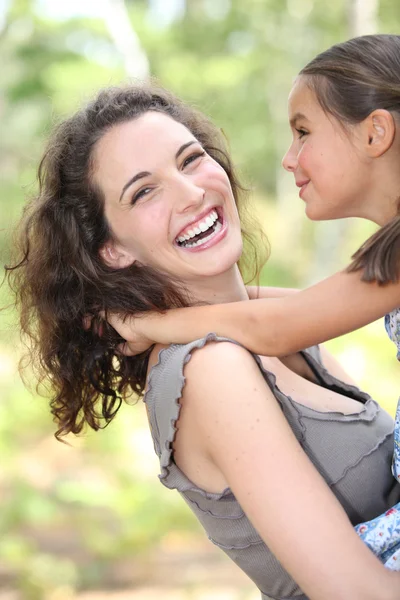Mother and daughter in her arms — Stock Photo, Image