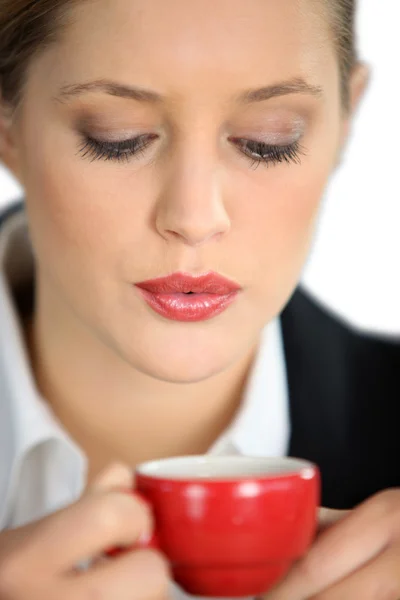 Woman blowing a hot drink — Stock Photo, Image
