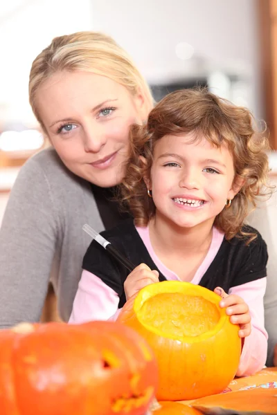 Girl decorating pumpkin — Stock Photo, Image