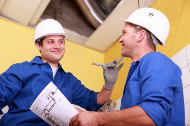 Electricians exchanging views clipart